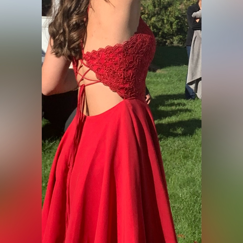 Flowy red homecoming dress with corset back and flower detailing